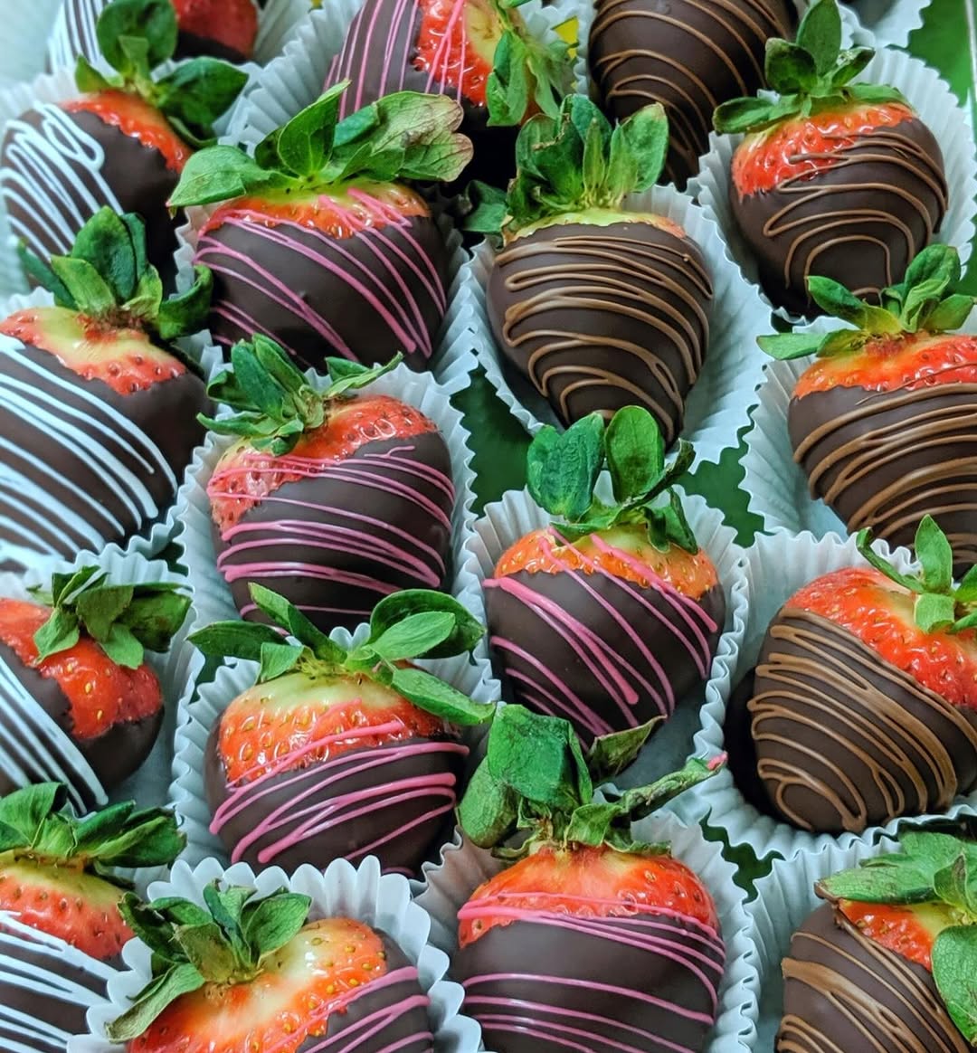 Chocolate-dipped strawberries with pink, white and milk chocolate drizzle