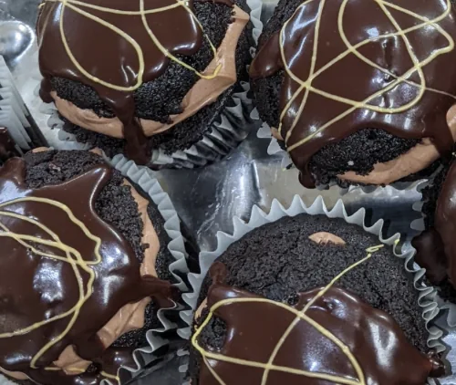 Chocolate-glazed cupcakes with gold drizzle